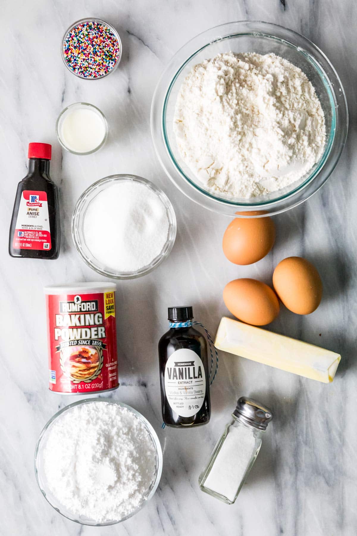 Overhead view of ingredients including anise extract, eggs, butter, and more.