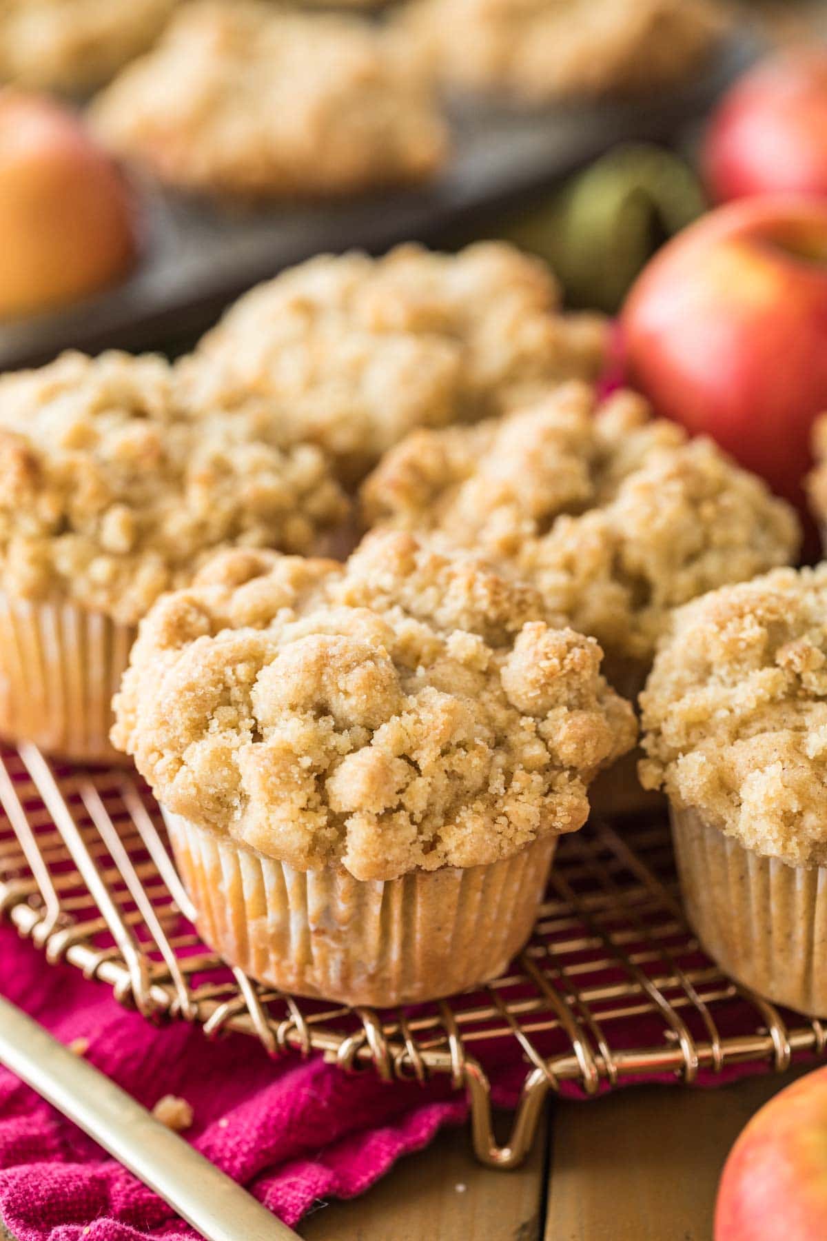 close-up view of apple muffins with a crumb topping on a metal cooling rack