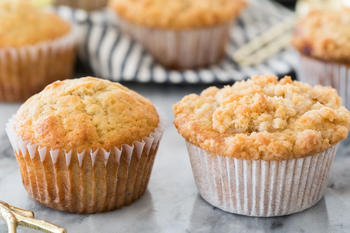 two muffins showing a side-by-side comparison of streusel topping vs no streusel