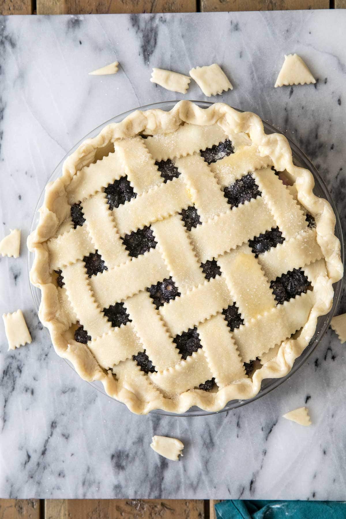 Overhead view of a pie with a lattice crust before baking.