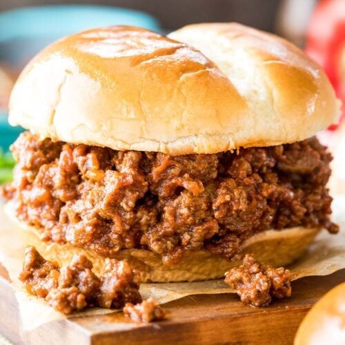 sloppy joe sandwich resting on a wood cutting board