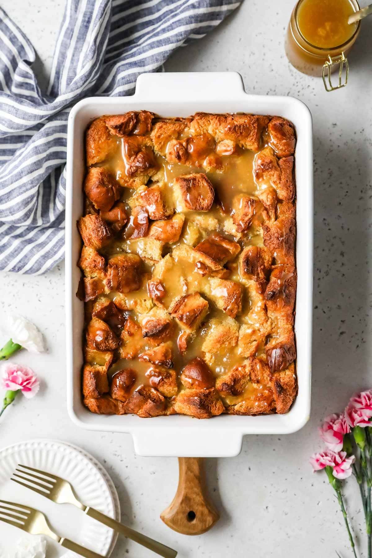 Overhead view of a bread pudding in a white casserole dish.