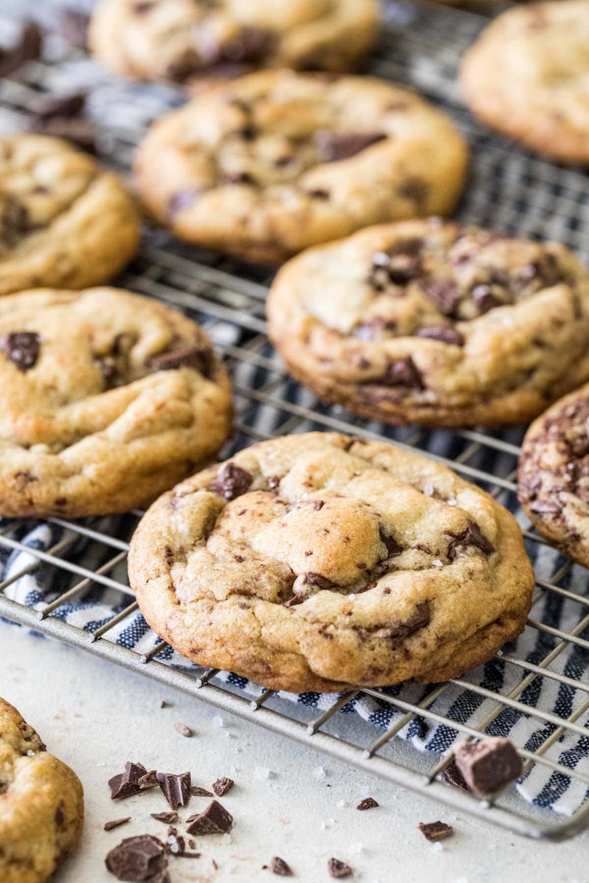 Brown butter chocolate chip cookies on a metal cooling rack.