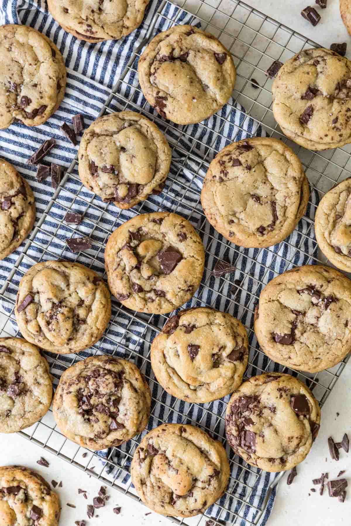 Overhead view of chocolate chip cookies made with brown butter on a metal cooling rack.