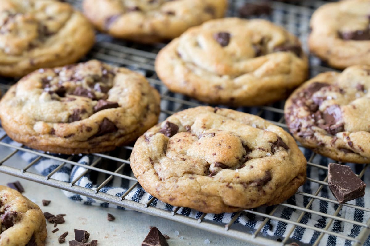 Brown butter chocolate chip cookies on a metal cooling rack.