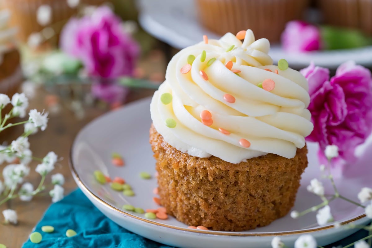 Carrot Cake Cupcake on a plate, surrounded by flowers