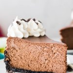 single image of a slice of chocolate cheesecake on white plate, title in teal bar at the top