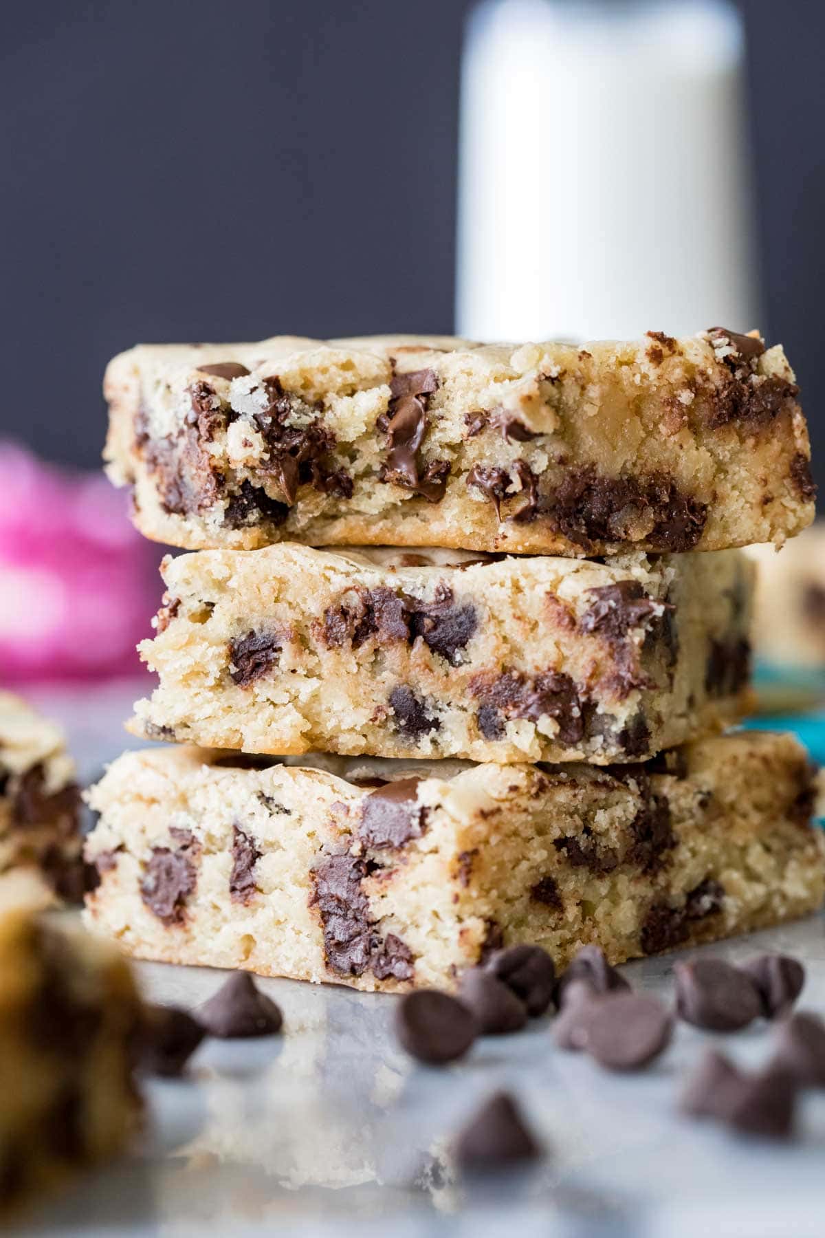 three stacked chocolate chip cookie bars studded with chocolate chips