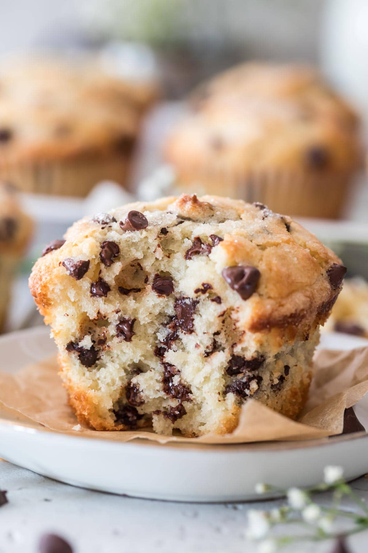cross section of a jumbo, bakery style chocolate chip muffin studded with chocolate chips of varying sizes