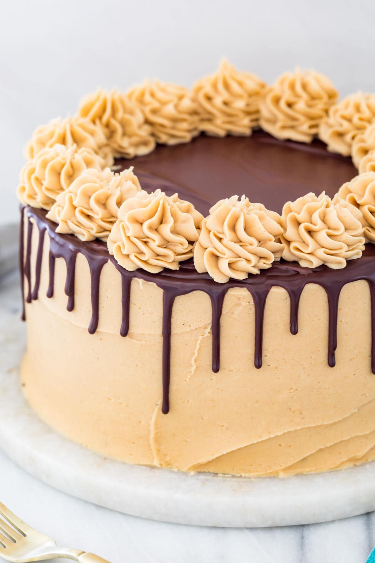 chocolate ganache drip on a peanut butter frosted cake