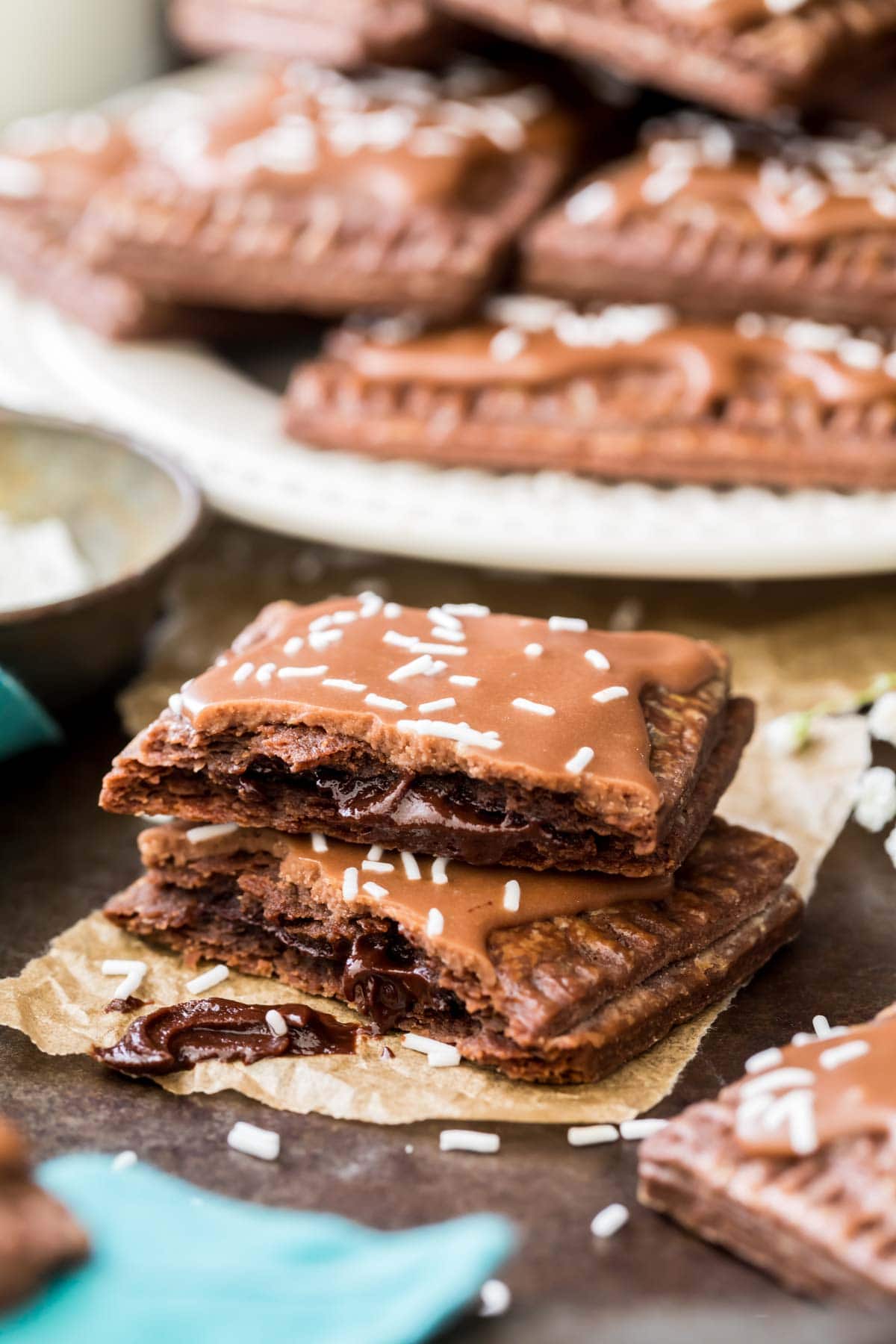 Two halves of a homemade chocolate pop tart stacked on top of each other to show the chocolate filled center