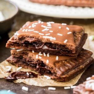 Two halves of a homemade chocolate pop tart stacked on top of each other to show the chocolate filled center