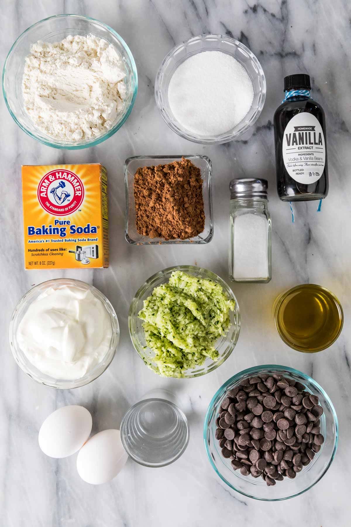 Overhead view of ingredients including shredded zucchini, cocoa powder, chocolate chips, and more.