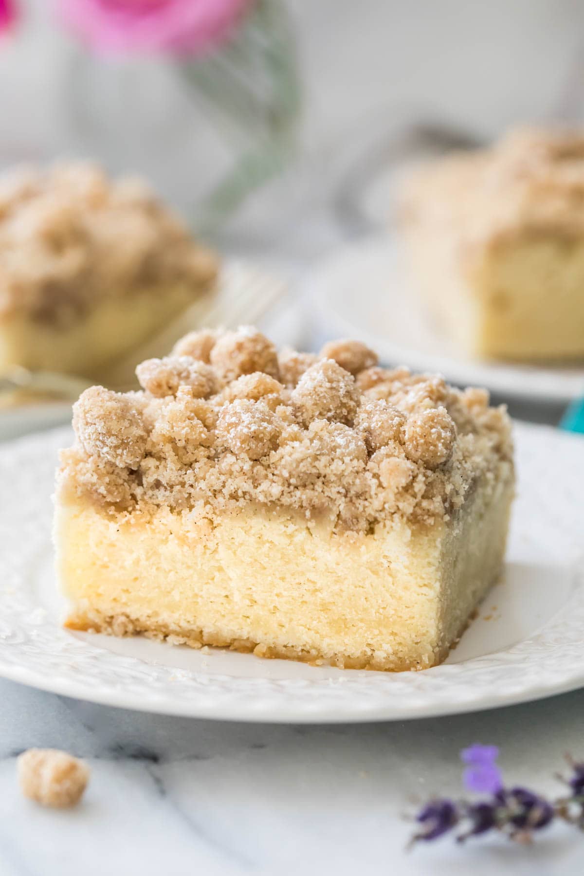 Slice of crumb cake on white plate.