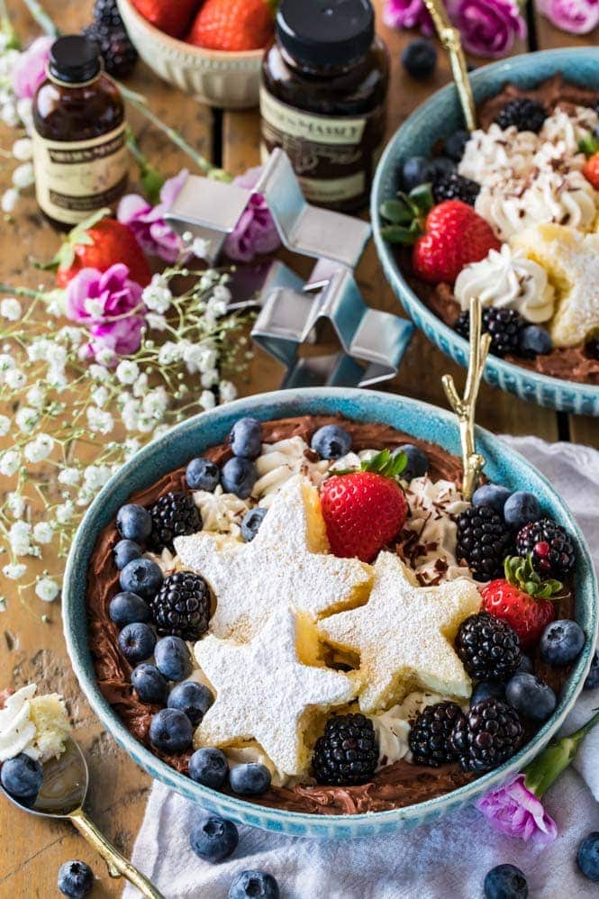 A dessert bowl decorated with star-shaped cake slices and fruit