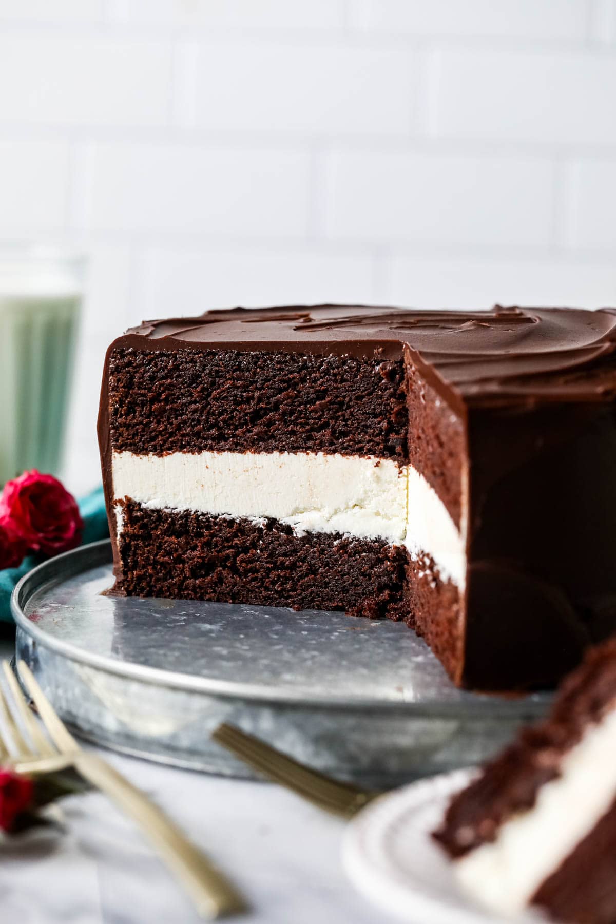 Cross section of a ding dong cake made with a creamy white filling and chocolate ganache topping.