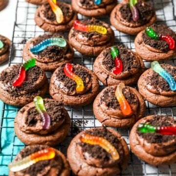 Cooling rack of dirt cookies topped with gummy worms.