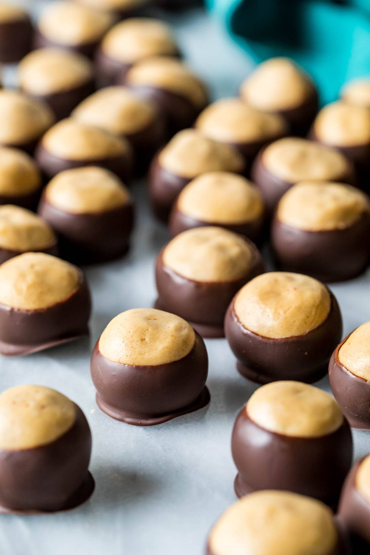 Over a dozen candies made from my buckeye recipe arranged on a marble board