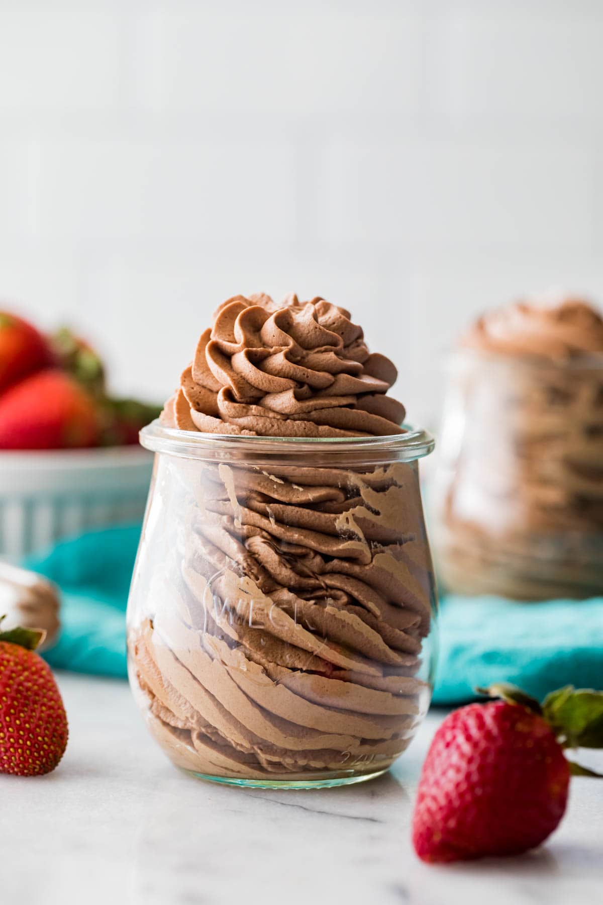 close-up view of chocolate whipped cream that's been piped into a small glass jar