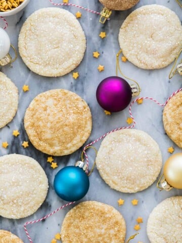 drop sugar cookies on marble surrounded by ornaments