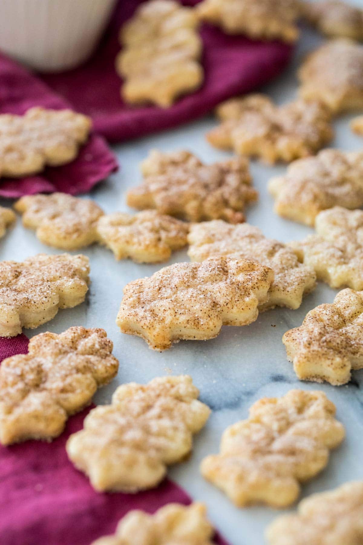 pie crust cookies cut into leaf shapes and dusted with cinnamon sugar