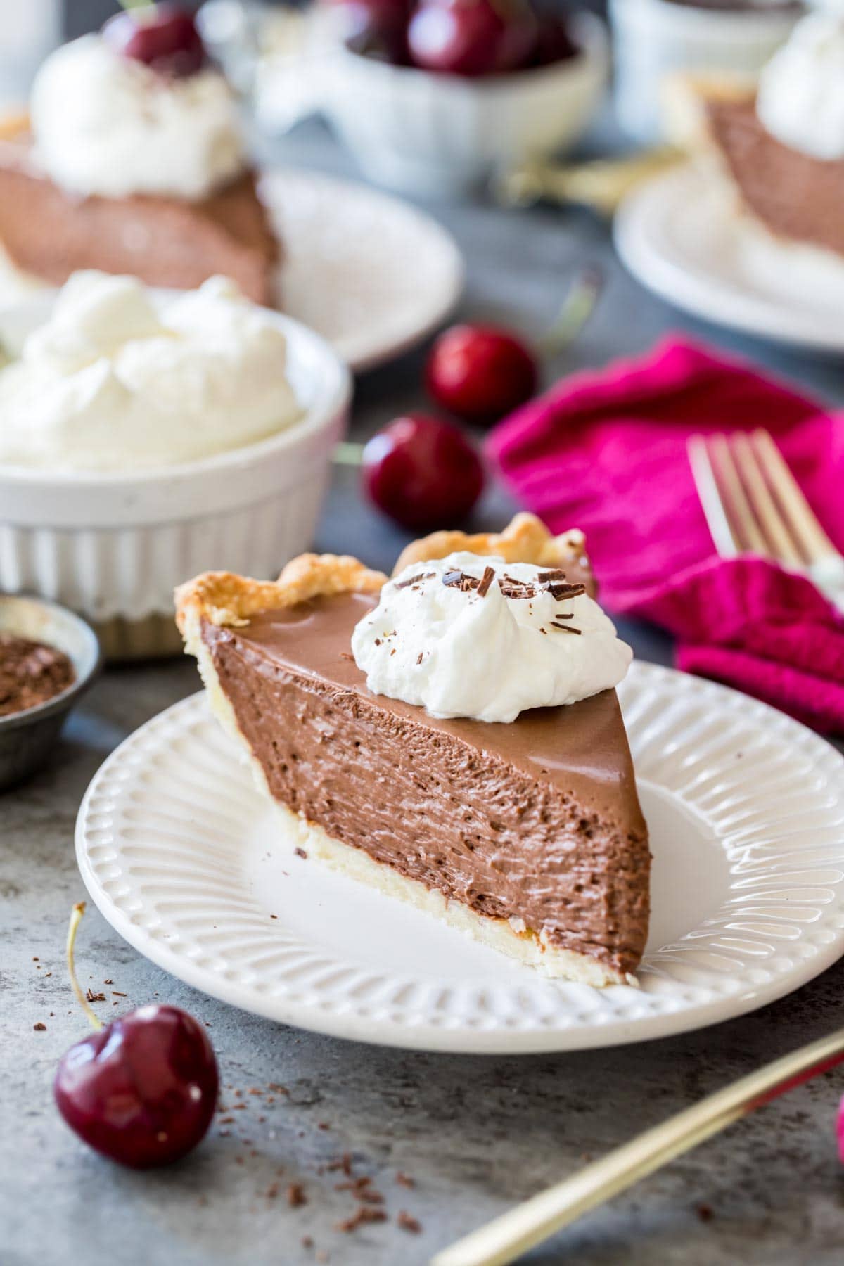 Slice of chocolate pie topped with whipped cream and chocolate shavings.