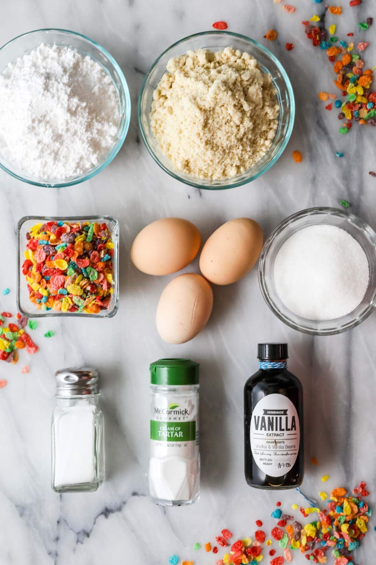 Overhead view of ingredients including fruity pebbles, almond flour, eggs, and more.