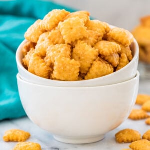 Stacked white bowls overflowing with homemade cheese crackers