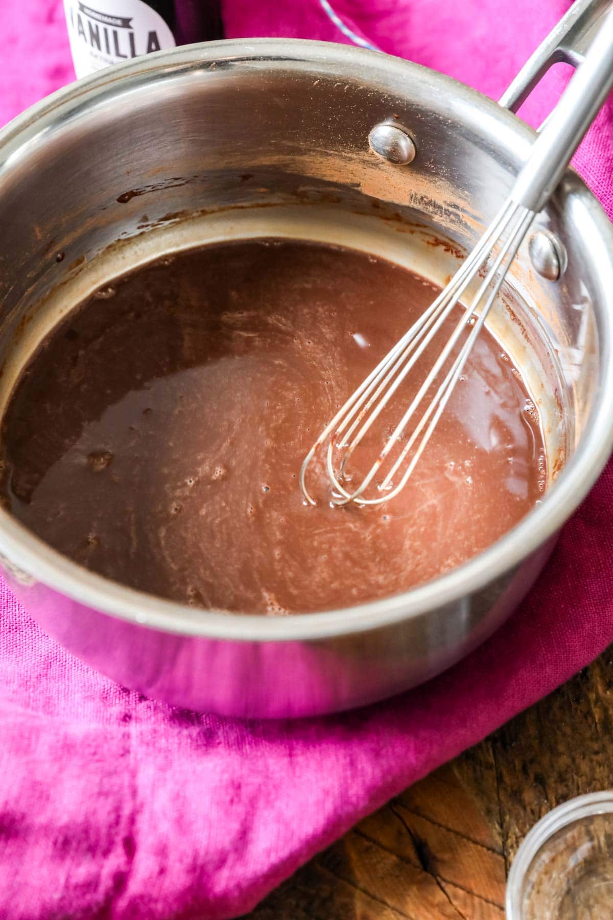 Cocoa and milk mixture darkening on the stovetop.