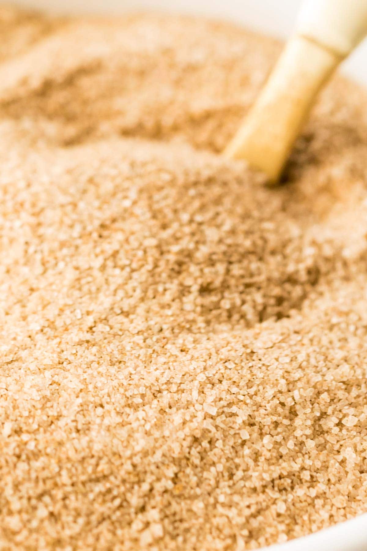 close-up view of a spiced sugar being stirred by a spoon
