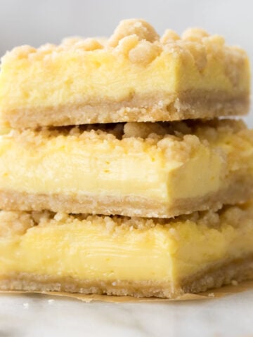 Three lemon crumb bars stacked on top of each other.