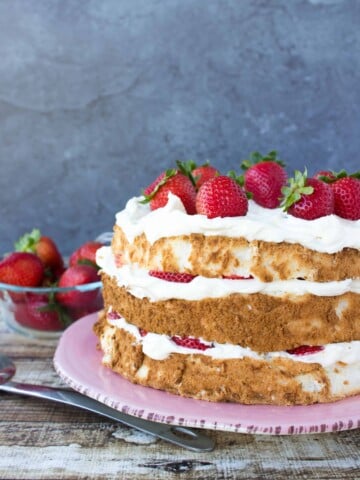 layered cake with strawberries on top and filling