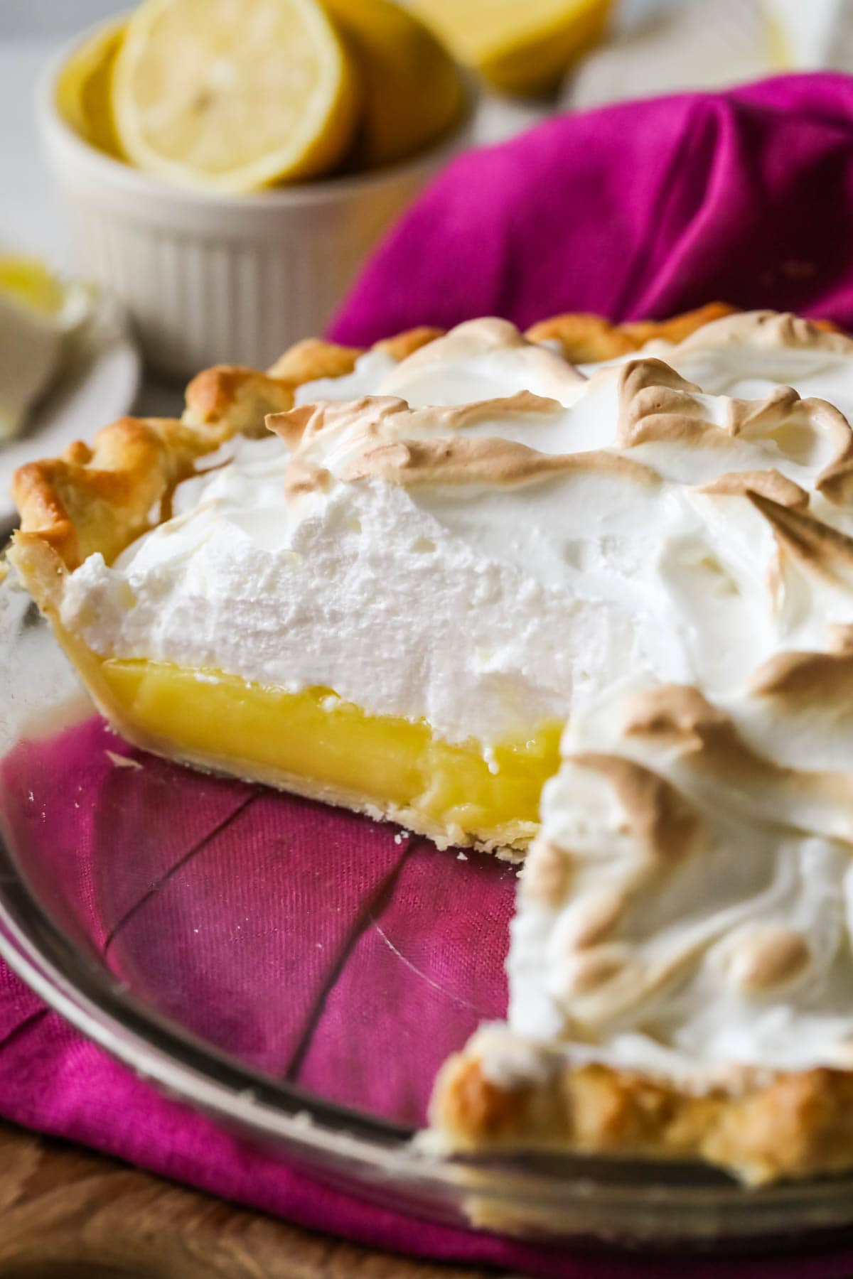 Cross section of a lemon meringue pie in a glass pie plate.