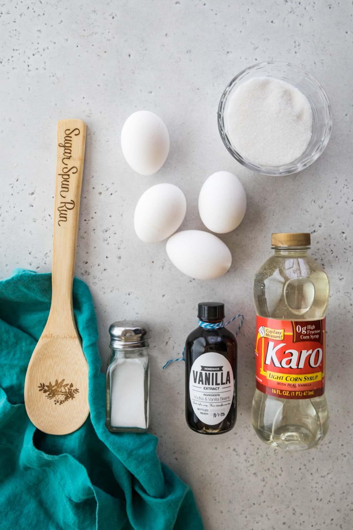 overhead view of ingredients including eggs, corn syrup, vanilla, sugar, and salt