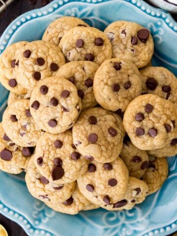 Overhead view of mini chocolate chip cookies on a plate.