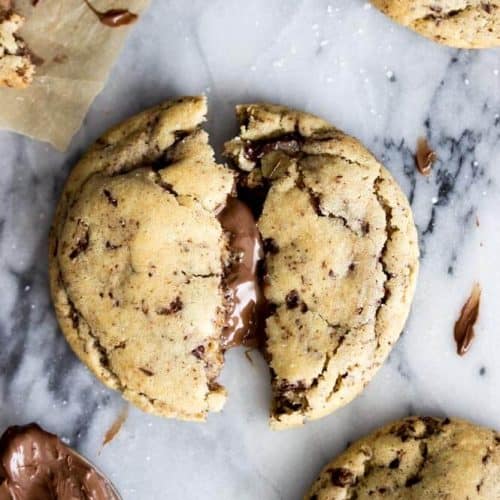 Overhead of nutella stuffed cookie broken in half with nutella filling