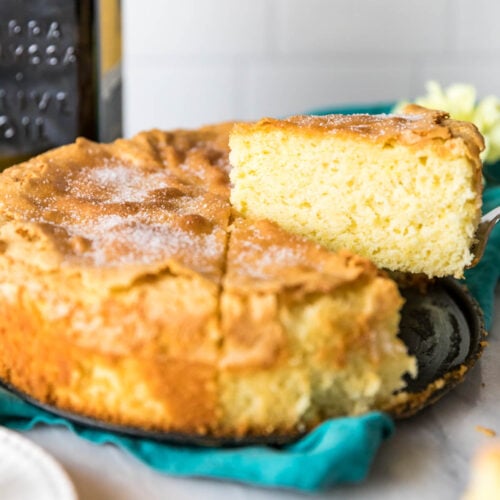 Slices being cut and served from an olive oil cake.