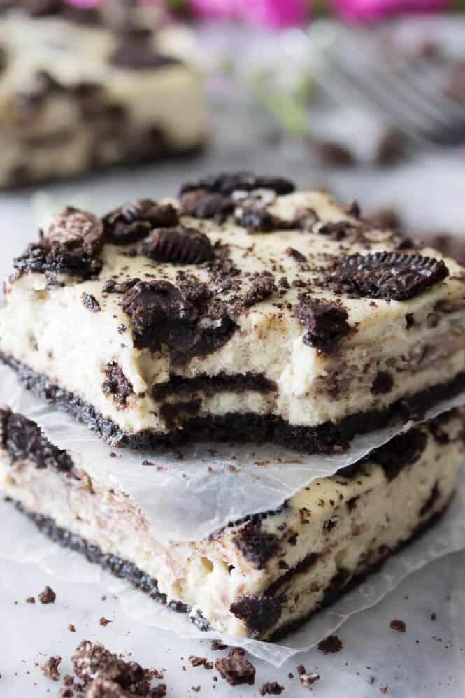 Cookies & cream cheesecake squares with a bite out of it -- showing creamy interior