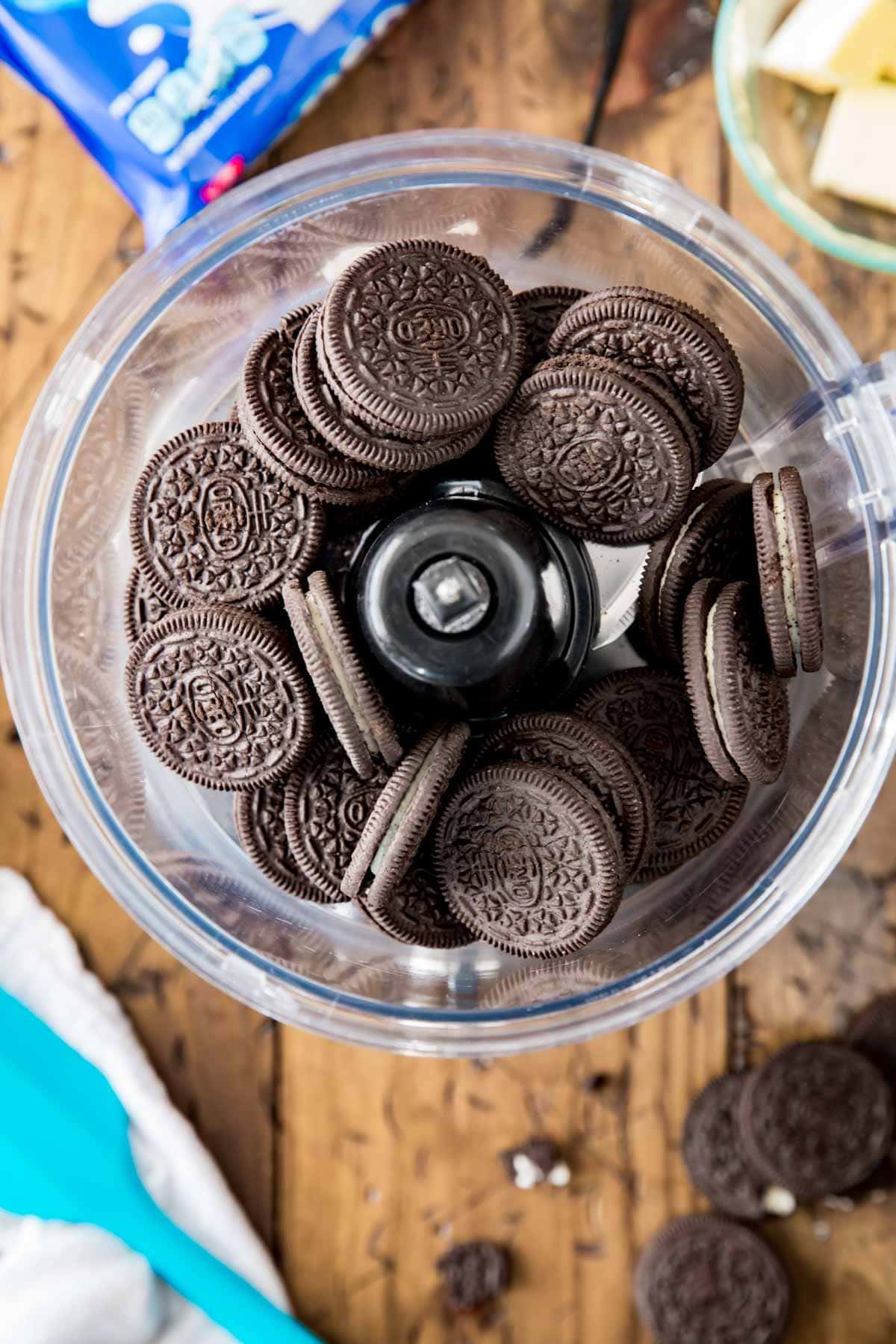 Oreo sandwich cookies in a food processor bowl.