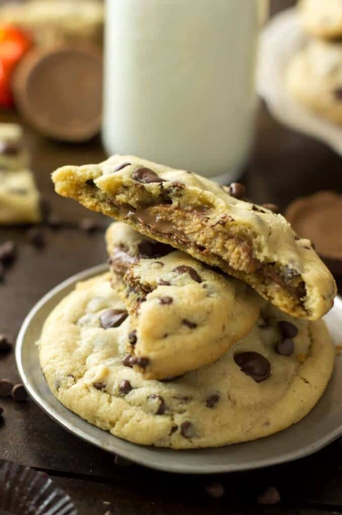 Peanut butter cup stuffed chocolate chip cookies, stacked on a plate