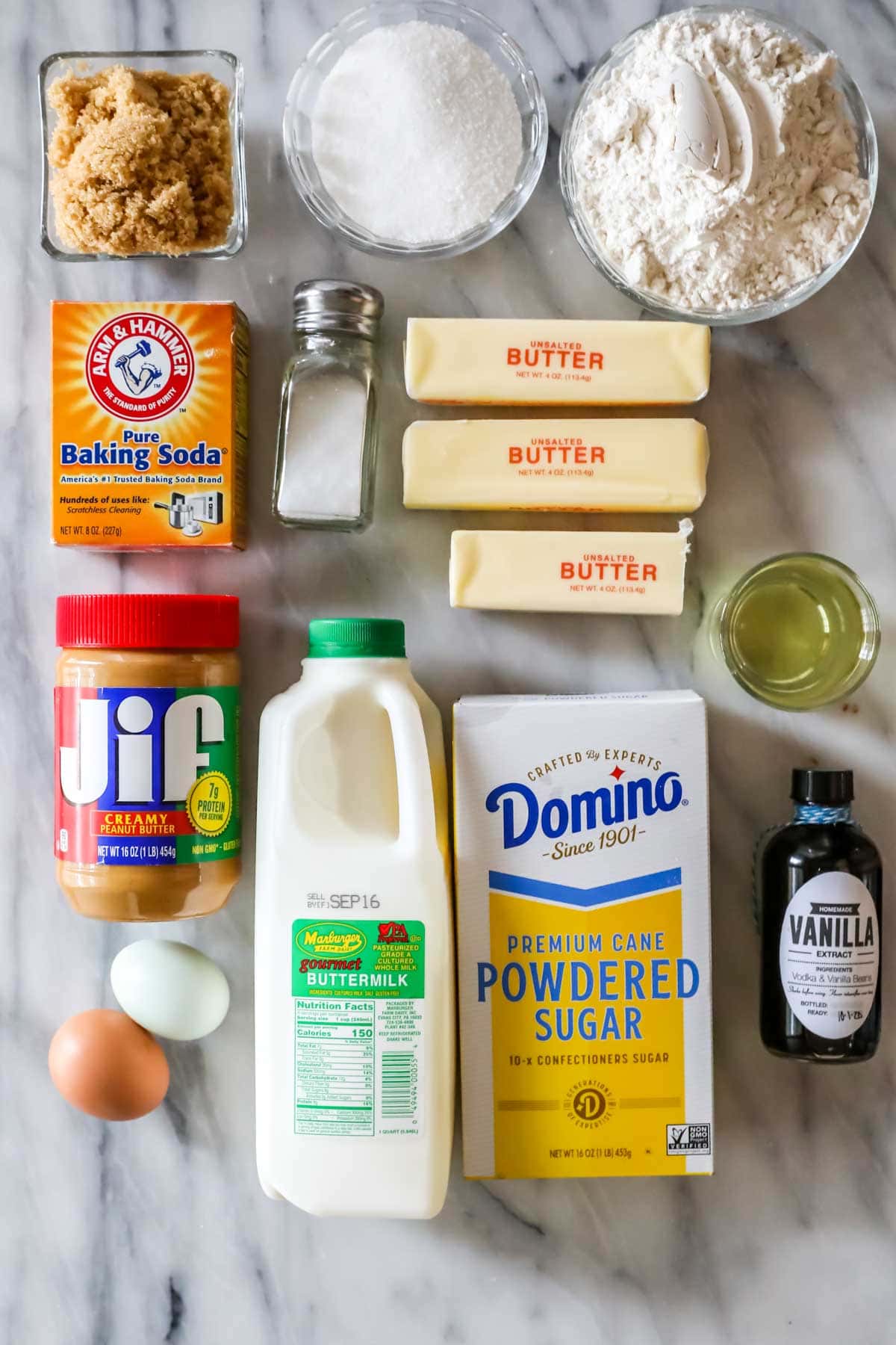 Overhead view of ingredients including butter, buttermilk, peanut butter, vanilla, and more.