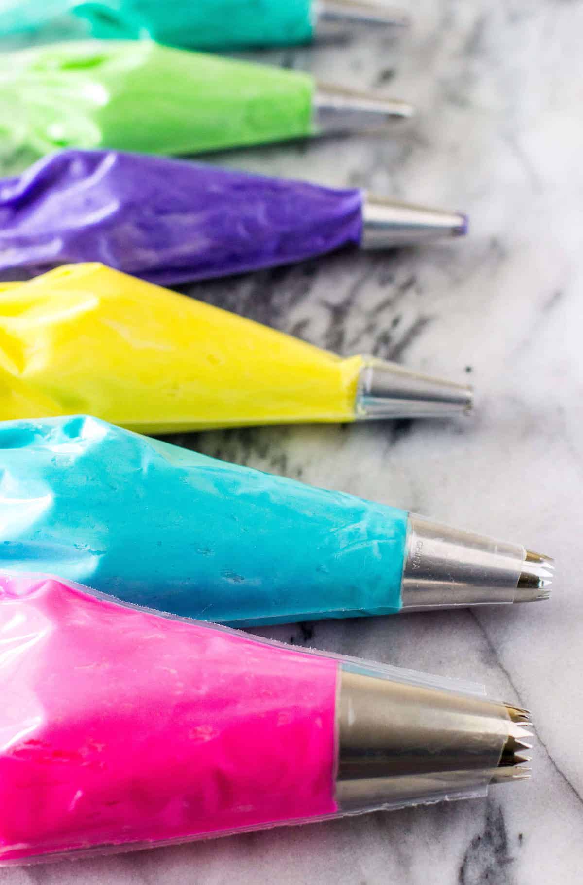 piping bags and tips filled with colored frosting