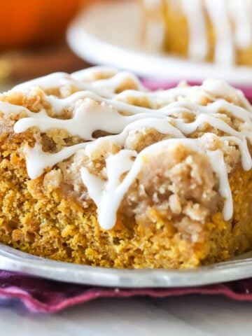 Square of pumpkin coffee cake on silver plate. Drizzled with vanilla glaze.