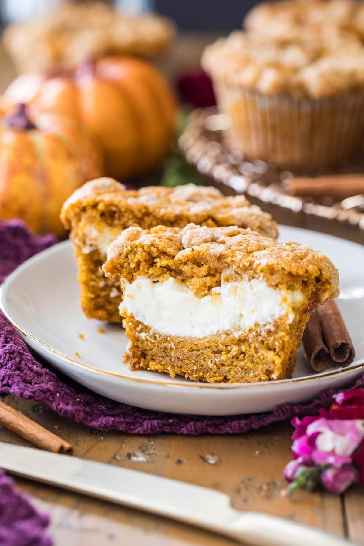 pumpkin cream cheese muffin that's been cut in half to show its cream cheese center