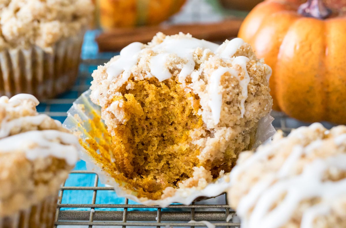 bite missing from a streusel topped and glazed muffin