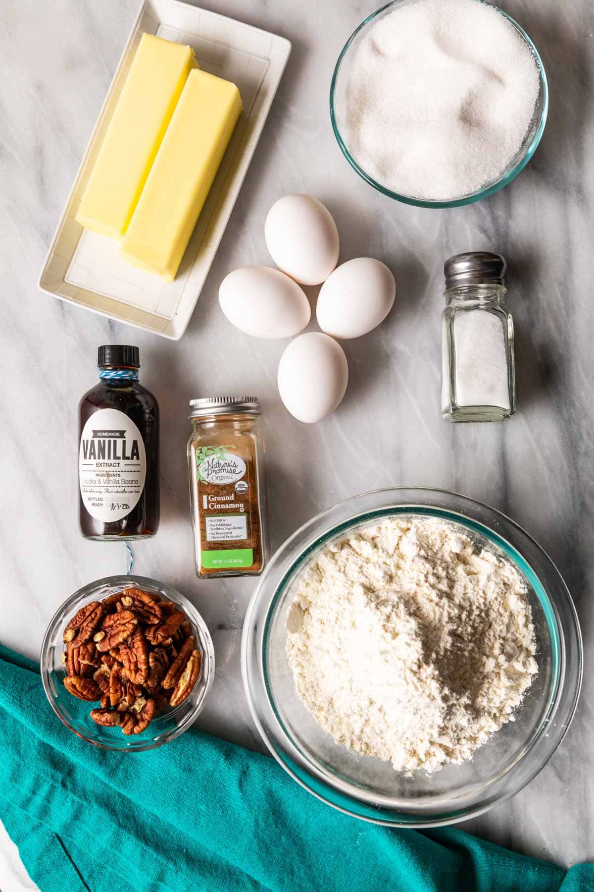 Overhead view of ingredients including eggs, pecan halves, sugar, and more.