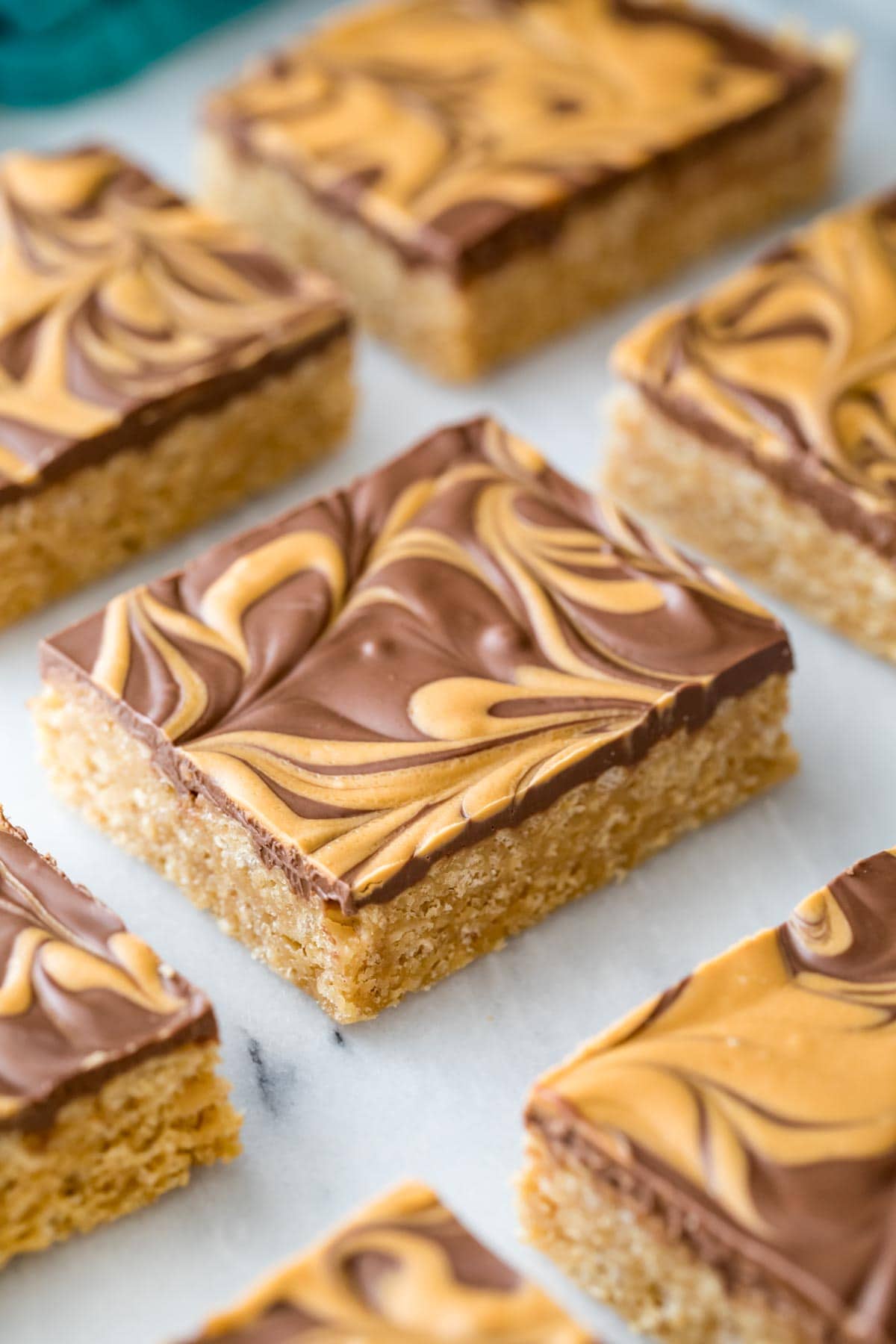 neatly cut scotcharoos with a swirled chocolate and butterscotch topping