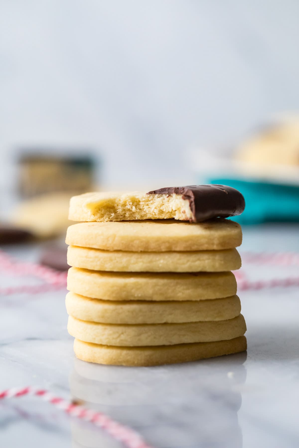 Stack of shortbread cookies with the top cookie missing a bite.
