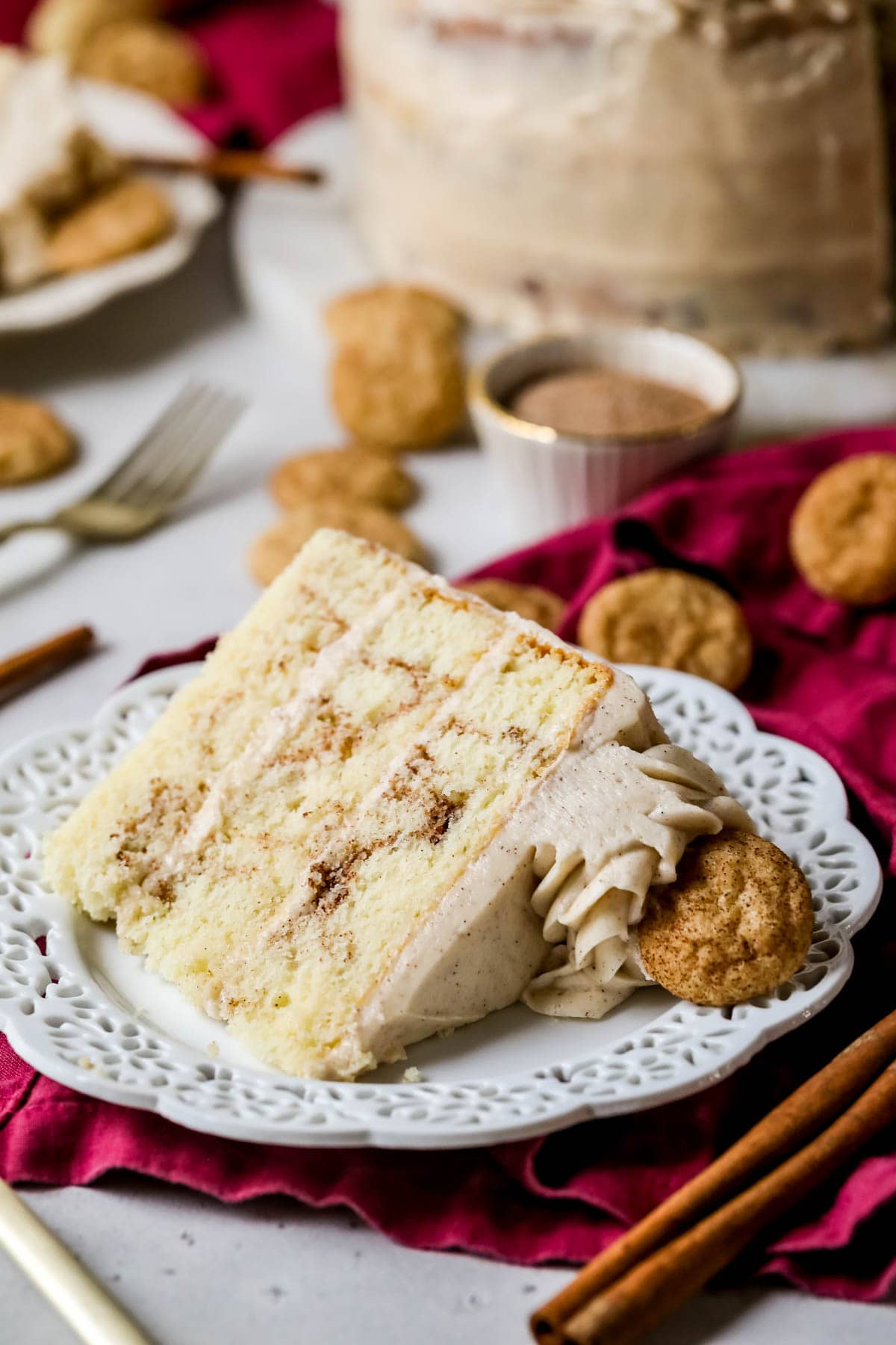 Slice of snickerdoodle cake on a white plate. 