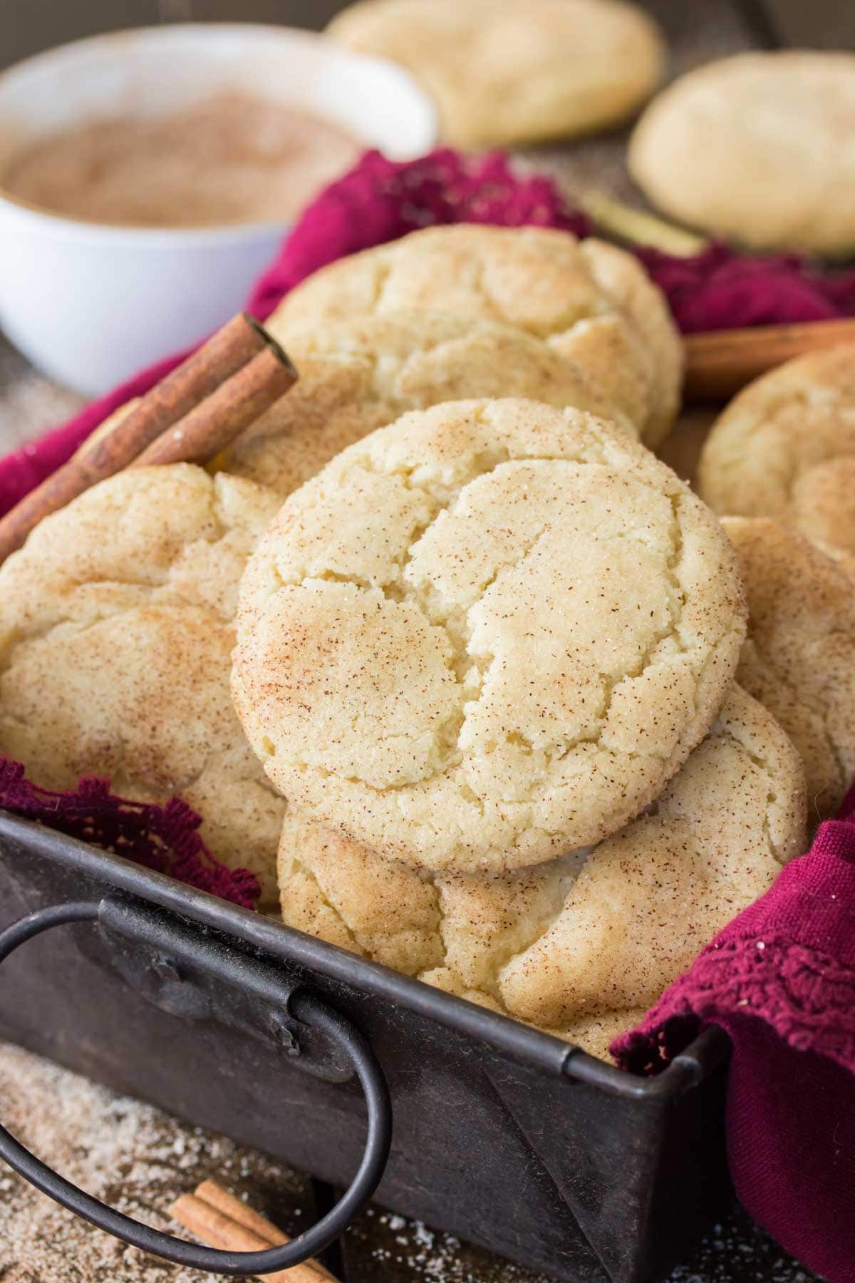 Crackly topped snickerdoodle cookies laying on top of each other.